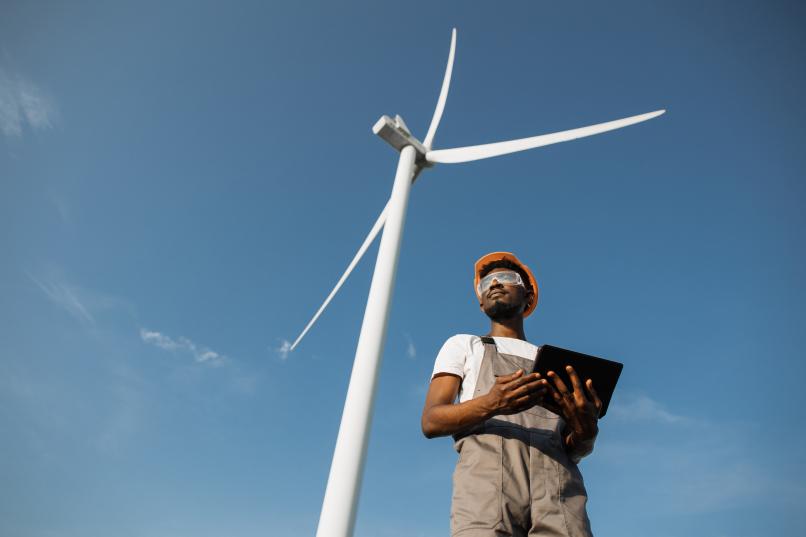 technician-using-tablet-for-work-on-farm-with-wind-2022-04-27-03-45-59-utc.jpg